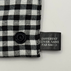 Black and white checkered fabric with a label reading 'Different cover, same fab bag :)' on a light gray background.