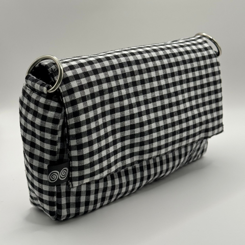 Black and white checkered handbag cover on a light gray background